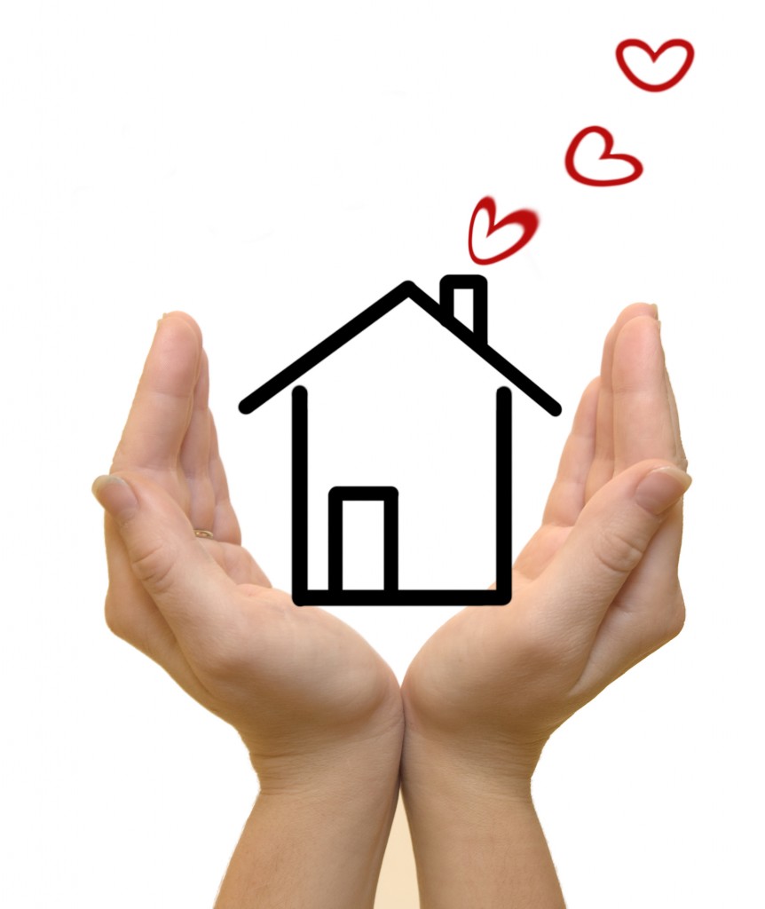 Hands protecting drawn house, hearts coming out of chimney